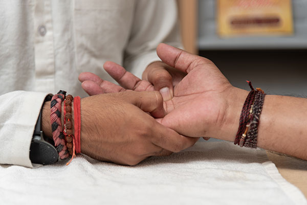 Close-up of acupuncture therapy applied to hand pressure points