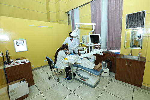 Dentist performing Patanjali dental treatment for cavity care